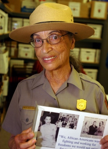 Ranger Betty Soskin with a photo of herself has a young woman.
